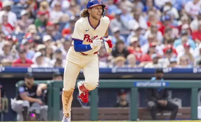 Philadelphia Phillies' Alec Bohm runs to first after hitting a double in the fifth inning of a baseball game against the Miami Marlins, Saturday, April 19, 2025, in Philadelphia. (AP Photo/Laurence Kesterson)