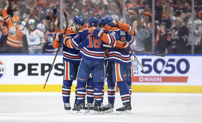 Edmonton Oilers players celebrate a goal against the Los Angeles Kings during the third period of an NHL playoff game in Edmonton on Sunday, April 27, 2025. (Jason Franson/The Canadian Press via AP)