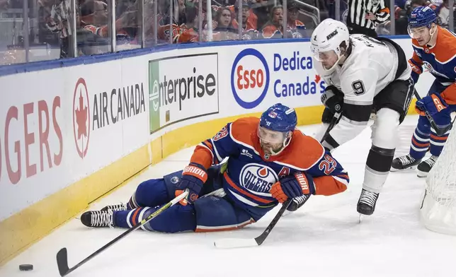 Los Angeles Kings' Adrian Kempe (9) trips up Edmonton Oilers' Leon Draisaitl (29) during the second period of an NHL playoff game in Edmonton on Sunday, April 27, 2025. (Jason Franson/The Canadian Press via AP)