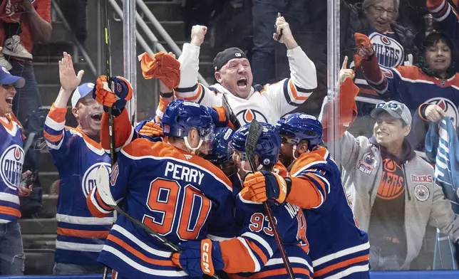 Edmonton Oilers players celebrate a goal against the Los Angeles Kings during an overtime of an NHL playoff gamen in Edmonton on Sunday, April 27, 2025. (Jason Franson/The Canadian Press via AP)