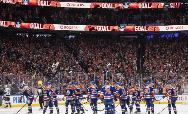 Edmonton Oilers players celebrate the win over the Los Angeles Kings during an overtime of an NHL playoff game in Edmonton on Sunday, April 27, 2025. (Jason Franson/The Canadian Press via AP)