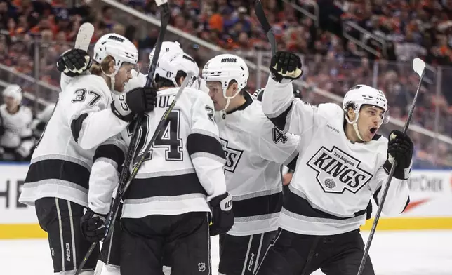 Los Angeles Kings' Trevor Moore, right, celebrates a goal against the Edmonton Oilers with teammates during the first period of Game 4 in an NHL hockey first-round playoff series in Edmonton, Alberta, Sunday, April 27, 2025. (Jason Franson/The Canadian Press via AP)