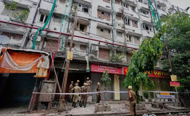 Firefighters inspect a hotel building which caught fire on Tuesday resulting in several deaths, in Kolkata, India, Wednesday, April 30, 2025. (AP Photo/Bikas Das)