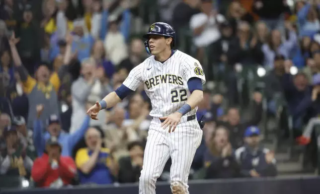 Milwaukee Brewers' Christian Yelich reacts after he scored during the fourth inning of a baseball game against the Athletics, Sunday, April 20, 2025, in Milwaukee. (AP Photo/Jeffrey Phelps)