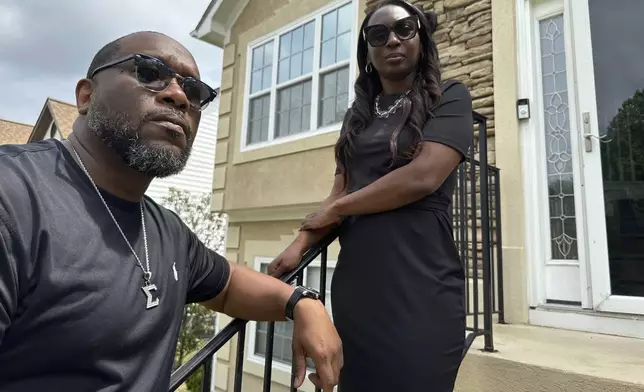 Toi Cliatt, left, and Trina Martin stand outside the home which the FBI mistakenly raided in 2017, in Atlanta on Friday, April 25, 2025. (AP Photo/Sudhin Thanawala)