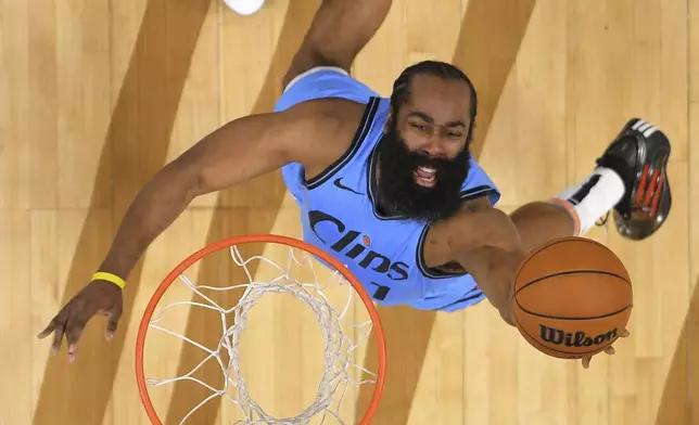 Los Angeles Clippers guard James Harden, below, shoots as Dallas Mavericks forward Anthony Davis defends during the first half of an NBA basketball game Saturday, April 5, 2025, in Inglewood, Calif. (AP Photo/Mark J. Terrill)