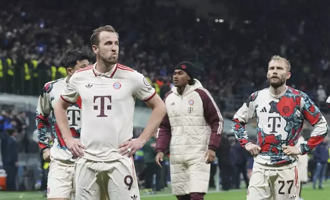 Bayern's Harry Kane, left, reacts at the end of the Champions League quarterfinal second leg soccer match between Inter Milan and Bayern Munich at the San Siro stadium in Milan, Italy, Wednesday, April 16, 2025. (AP Photo/Antonio Calanni)