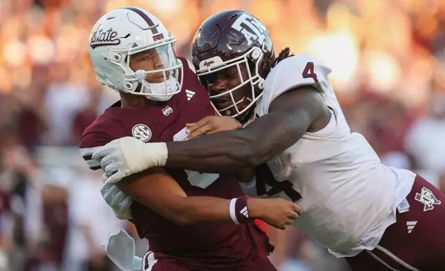 FILE - Texas A&amp;M defensive lineman Shemar Stewart (4) tackles Mississippi State quarterback Michael Van Buren Jr. (0) during the second half of an NCAA college football game on Saturday, Oct. 19, 2024, in Starkville, Miss. (AP Photo/Randy J. Williams, File)
