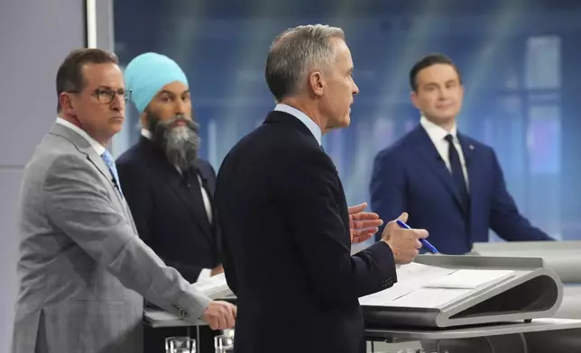 Bloc Quebecois Leader Yves-Francois Blanchet, New Democratic Party Leader Jagmeet Singh and Conservative Leader Pierre Poilievre listen to Liberal leader Mark Carney speak during the French-language federal leaders' debate, in Montreal, Wednesday, April 16, 2025. (Sean Kilpatrick/The Canadian Press via AP)