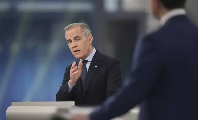 Liberal Leader Mark Carney makes a point towards Conservative Leader Pierre Poilievre during the French-language federal leaders' debate in Montreal, Wednesday, April 16, 2025. (Christopher Katsarov/The Canadian Press via AP)