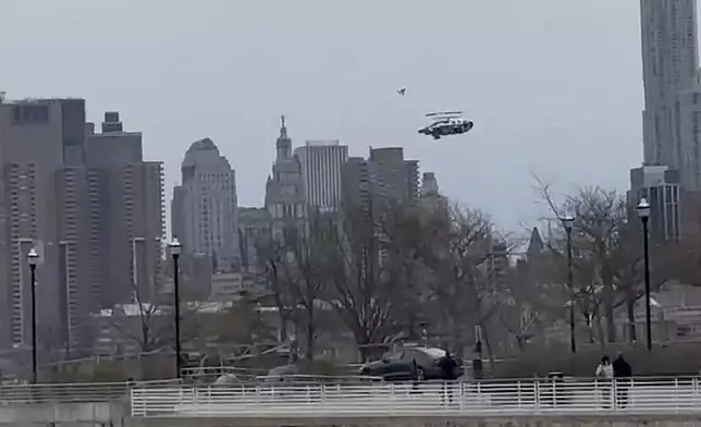 In this photo taken from video, a helicopter falls from the sky into the Hudson River , Thursday, April 10, 2025, in Jersey City, N.J. (Bruce Wall via AP)