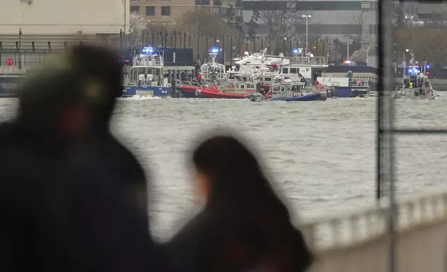 As seen from Pier 40 in New York, police and fire crews from New York and New Jersey respond to the scene Thursday, April 10, 2025, where a helicopter went down in the Hudson River between Manhattan and the New Jersey waterfront. (AP Photo/Yuki Iwamura)