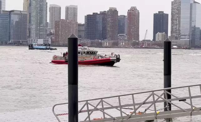 A New York Fire Department Marine 1 boat departs from Pier 40, Thursday, April 10, 2025, in New York, across from where a helicopter went down in the Hudson River in Jersey City, N.J. (AP Photo/Jennifer Peltz)