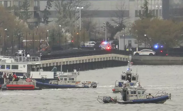 As seen from Pier 40 in New York, police and fire crews from New York and New Jersey respond to the scene Thursday, April 10, 2025, where a helicopter went down in the Hudson River between Manhattan and the New Jersey waterfront. (AP Photo/Yuki Iwamura)