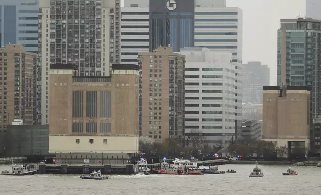 As seen from Pier 40 in New York, police and fire crews from New York and New Jersey respond to the scene where a helicopter crashed into the Hudson River, Thursday, April 10, 2025, in Jersey City, N.J. (AP Photo/Yuki Iwamura)