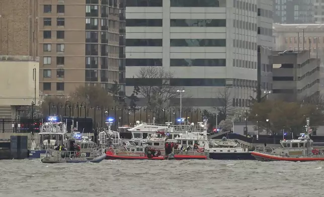 As seen from Pier 40 in New York, police and fire crews from New York and New Jersey respond to the scene Thursday, April 10, 2025, where a helicopter went down in the Hudson River between Manhattan and the New Jersey waterfront. (AP Photo/Yuki Iwamura)