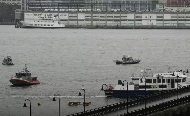 First responders from New Jersey and New York respond to the scene where a helicopter crashed in the Hudson River, Thursday, April 10, 2025, in Jersey City, N.J. (AP Photo/Seth Wenig)