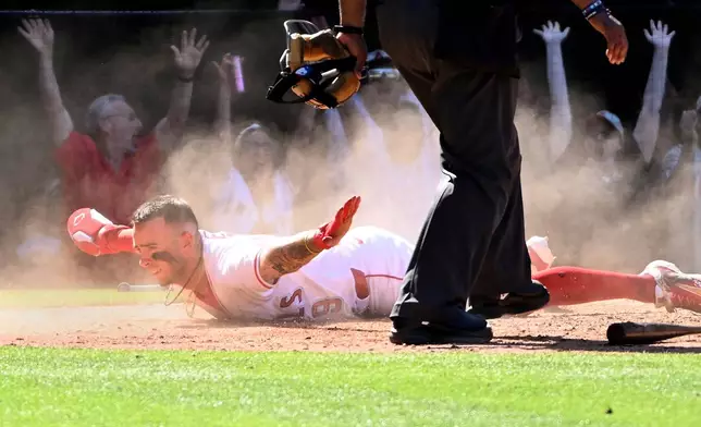 Los Angeles Angels' Zach Neto (9) beats the tag of San Francisco Giants catcher Sam Huff (23) to score the winning run during the ninth inning of a baseball game Sunday, April 20, 2025, in Anaheim, Calif. (AP Photo/Wally Skalij)