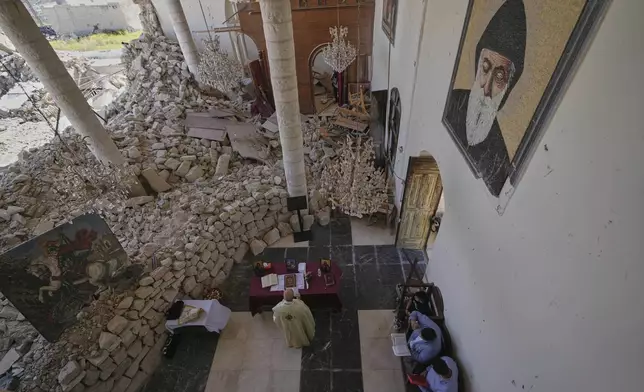 Worshippers gather for Easter Mass inside the ruins of St. George Melkite Catholic Church, damaged by Israeli airstrike, in Dardghaya, southern Lebanon, Sunday, April 20, 2025. (AP Photo/Hassan Ammar)