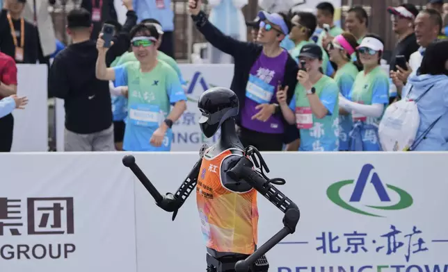 The Sky Project Ultra robot also known as Tien Kung Ultra crosses the finish line to win the Humanoid Robot Half-Marathon held in Beijing on Saturday, April 19, 2025. (AP Photo/Ng Han Guan)