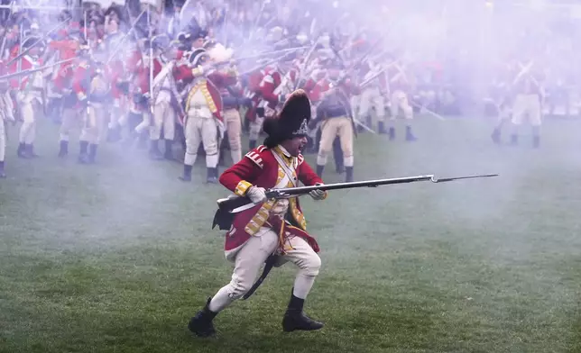 British Regulars advance on New England colonial militia, also known as a Minutemen, during a reenactment celebration of the 250th anniversary of the Battle of Lexington and start of the American Revolution, Saturday, April 19, 2025, in Lexington, Mass. (AP Photo/Charles Krupa)