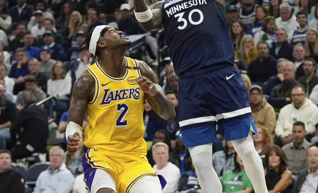 Minnesota Timberwolves forward Julius Randle (30) goes up for a shot as Los Angeles Lakers forward Jarred Vanderbilt (2) defends during the first half of Game 3 of an NBA basketball first-round playoff series, Friday, April 25, 2025, in Minneapolis. (AP Photo/Abbie Parr)