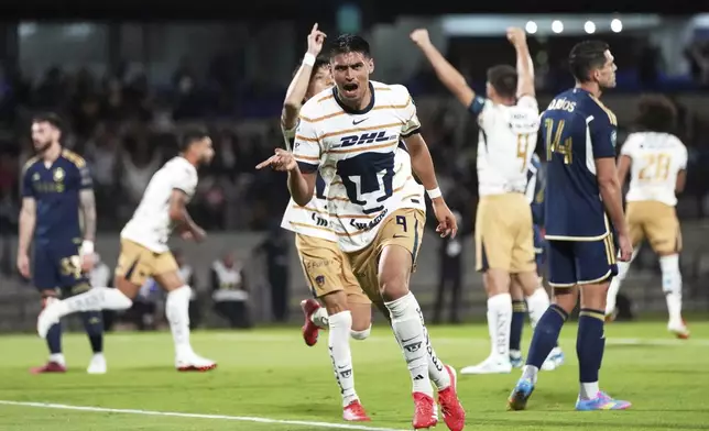 Guillermo Martinez of Mexico's Pumas celebrates scoring his side's first goal against Canada's Vancouver Whitecaps during a CONCACAF Champions Cup second leg quarterfinal soccer match in Mexico City, Wednesday, April 9, 2025. (AP Photo/Eduardo Verdugo)