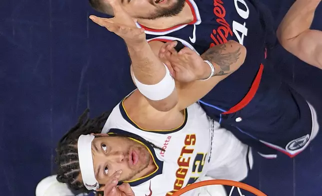 Denver Nuggets forward Aaron Gordon, bottom, and Los Angeles Clippers center Ivica Zubac (40) reach for a rebound during the first half in Game 3 of an NBA basketball first-round playoff series Thursday, April 24, 2025, in Inglewood, Calif. (AP Photo/Mark J. Terrill)