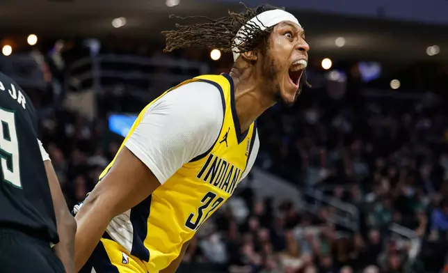 Indiana Pacers' Myles Turner (33) reacts after dunking over Milwaukee Bucks' Giannis Antetokounmpo during the second half of Game 4 of a first-round NBA basketball playoff series Sunday, April 27, 2025, in Milwaukee. (AP Photo/Jeffrey Phelps)