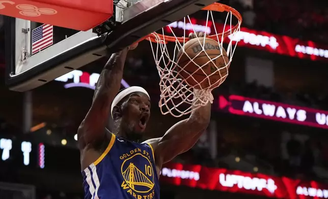 Golden State Warriors forward Jimmy Butler III (10) dunks during the second half of Game 1 of an NBA basketball first-round playoff series against the Houston Rockets in Houston, Sunday, April 20, 2025. (AP Photo/Ashley Landis)