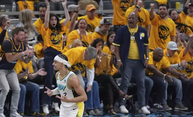 Indiana Pacers' Andrew Nembhard (2) celebrates after making a 3-point basket during the first half of a first-round NBA basketball playoff game against the Milwaukee Bucks, Saturday, April 19, 2025, in Indianapolis. (AP Photo/Michael Conroy)