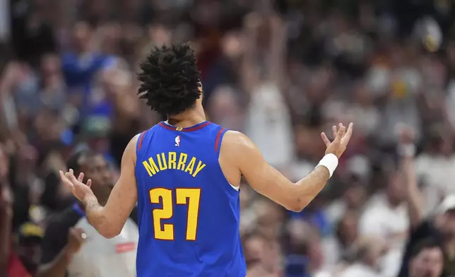 Denver Nuggets guard Jamal Murray gestures to the crowd after hitting a 3-point basket against the Los Angeles Clippers in the second half of Game 1 of an NBA first-round playoff series Saturday, April 19, 2025, in Denver. (AP Photo/David Zalubowski)