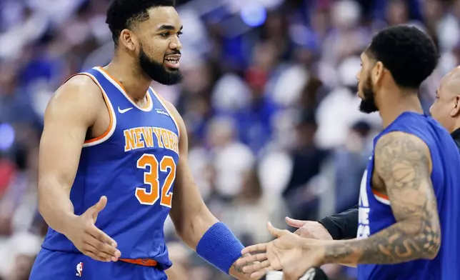 New York Knicks center Karl-Anthony Towns (32) celebrates with teammates during the first half of Game 3 of an NBA basketball first-round playoff series against the Detroit Pistons, Thursday, April 24, 2025, in Detroit. (AP Photo/Duane Burleson)