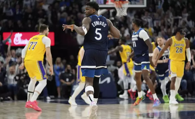Minnesota Timberwolves guard Anthony Edwards (5) gestures after making a 3-point shot during the second half of Game 3 of an NBA basketball first-round playoff series against the Los Angeles Lakers, Friday, April 25, 2025, in Minneapolis. (AP Photo/Abbie Parr)