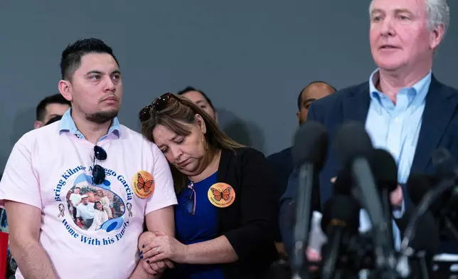 Sen. Chris Van Hollen, D-Md., accompanied by Cesar Abrego Garcia, from left, and Cecilia Garcia, speaks during a news conference upon his arrival from meeting with Kilmar Abrego Garcia in El Salvador, at Washington Dulles International Airport, in Chantilly, Va., Friday, April 18, 2025. (AP Photo/Jose Luis Magana)