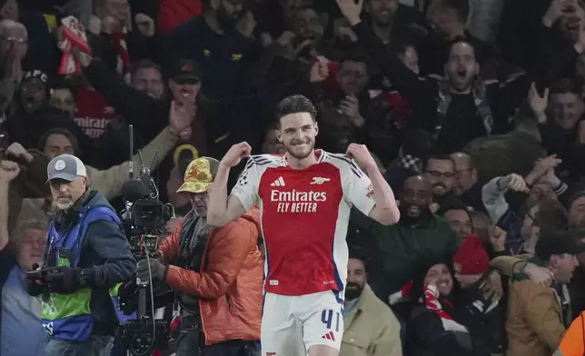 Arsenal's Declan Rice celebrates after scoring his side's second goal during the Champions League quarterfinal first leg soccer match between Arsenal and Real Madrid at the Emirates Stadium in London, Tuesday, April 8, 2025. (AP Photo/Frank Augstein)