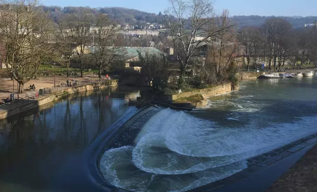 The River Avon in the World Heritage site of Bath, England, Wednesday, March 5, 2025 with the backdrop of the rugby stadium. (AP Photo/Frank Augstein)