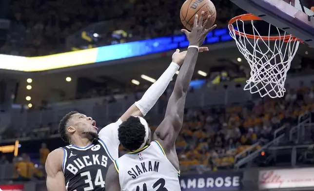 Milwaukee Bucks' Giannis Antetokounmpo (34) heads to the basket as Indiana Pacers' Pascal Siakam (43) defends during the second half of a first-round NBA basketball playoff game, Saturday, April 19, 2025, in Indianapolis. (AP Photo/Michael Conroy)