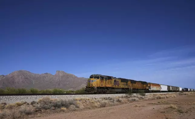 A Union Pacific freight train travels along the tracks, Thursday, April 17, 2025, in Eloy, Ariz. (AP Photo/Ross D. Franklin)