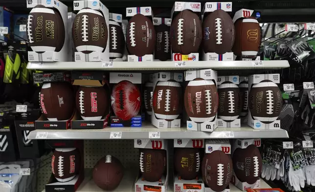 Footballs are displayed on shelves at a Walmart, Wednesday, April 16, 2025, in Groton, Conn. (AP Photo/Julia Demaree Nikhinson)
