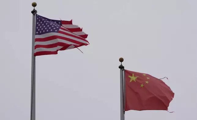 A flag of the United States flies next to a flag of China in Chinatown in San Francisco, Friday, April 18, 2025. (AP Photo/Jeff Chiu)