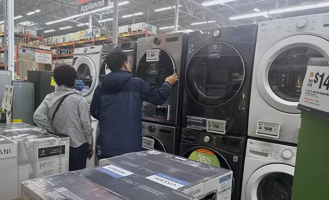 Shoppers look at washers and dryers at a Home Depot store Thursday, April 17, 2025, in Orlando, Fla. (AP Photo/John Raoux)