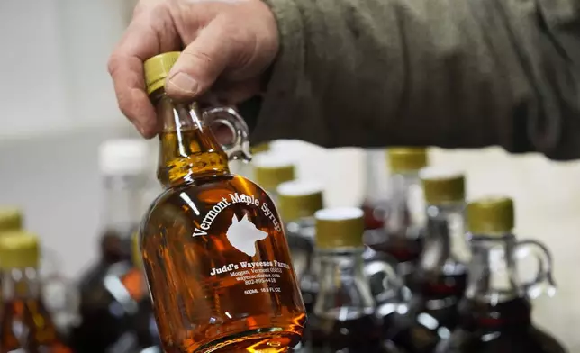 A bottle of maple syrup is placed on a shelf at Judd's Wayeeses Farms in Morgan, Vt., on Friday, April 11, 2025. (AP Photo/Robert F. Bukaty)