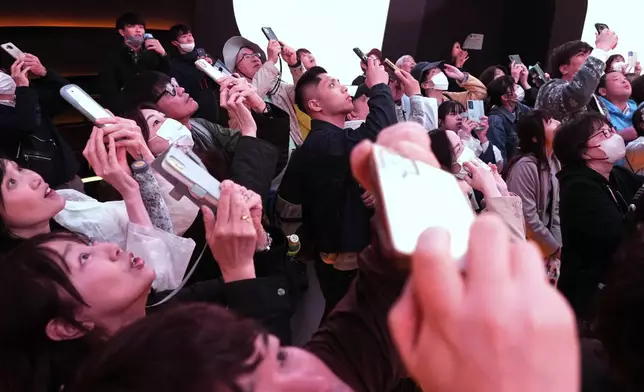 People visit the U.S. pavilion on the opening day of the Expo 2025 in Osaka, central Japan, Sunday, April 13, 2025. (AP Photo/Hiro Komae)