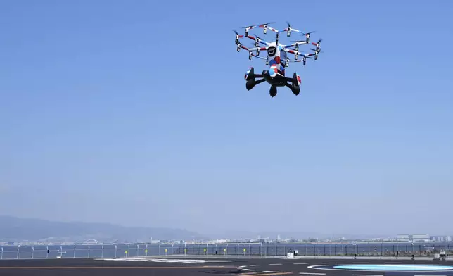 A pilot rides a Hexa battery-powered aircraft during its demonstration at the Expo 2025 in Osaka, western Japan, Monday, April 14, 2025. (AP Photo/Hiro Komae)