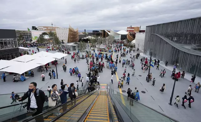 People visit the opening day of the Expo 2025 in Osaka, central Japan, Sunday, April 13, 2025. (AP Photo/Hiro Komae)