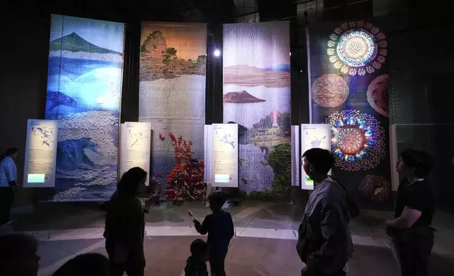 People visit the pavilion of the Philippines on the opening day of the Expo 2025 in Osaka, central Japan, Sunday, April 13, 2025. (AP Photo/Hiro Komae)