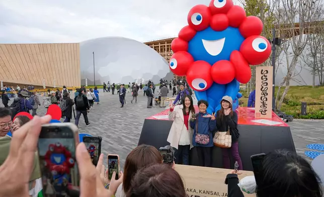 Visitors take photos on the opening day of Osaka Expo 2025 in Osaka, western Japan, Sunday, April 13, 2025. (AP Photo/Hiro Komae)