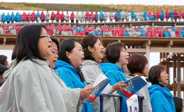 Participants sing Beethoven's "Ode to Joy" on the opening day of Osaka Expo 2025 in Osaka, western Japan, Sunday, April 13, 2025. (AP Photo/Hiro Komae)