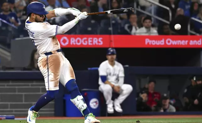 Toronto Blue Jays' Bo Bichette (11) hits a double against the Boston Red Sox in the third inning of a baseball game in Toronto on Tuesday, April 29, 2025. (Jon Blacker/The Canadian Press via AP)